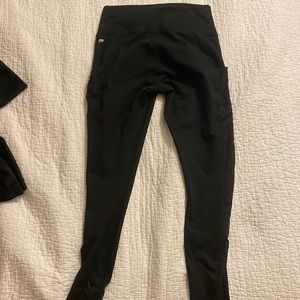 All black Fabletics leggings with mesh pockets. Size Small. Good condition.